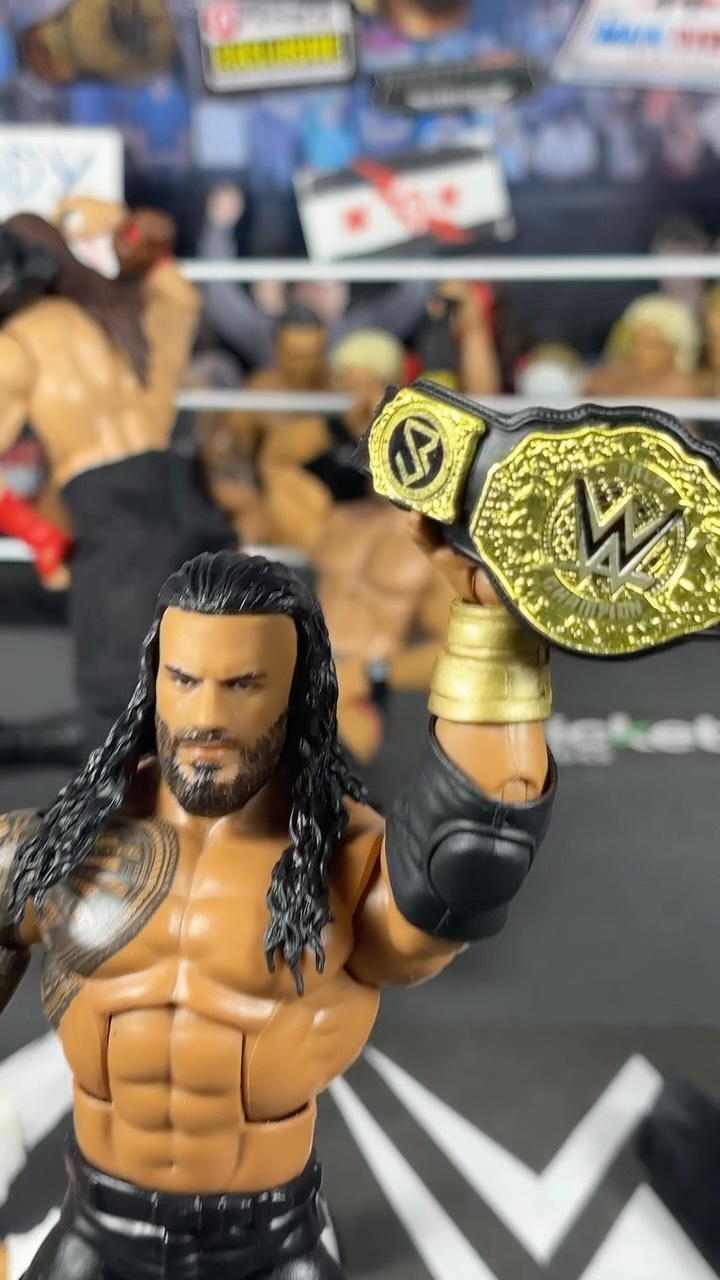 Roman Reigns action figure holding ...