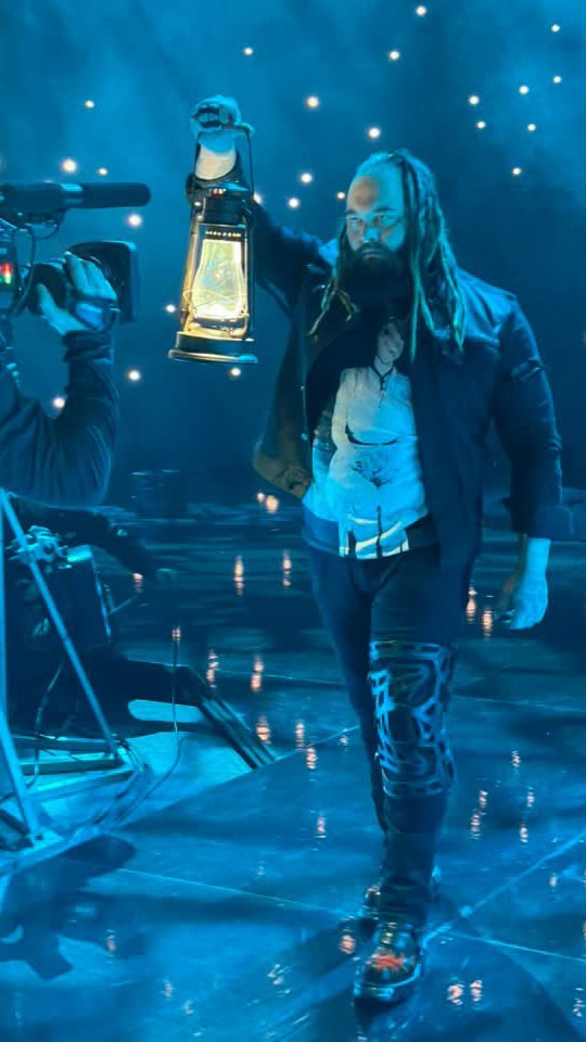 Bray Wyatt holding a lantern in the...