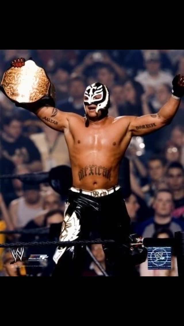Rey Mysterio celebrates with a cham...