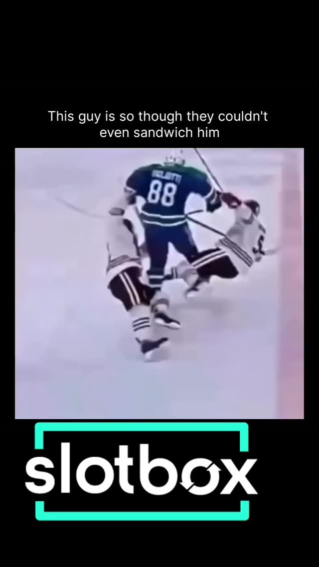 Hockey player shrugs off a two-man ...
