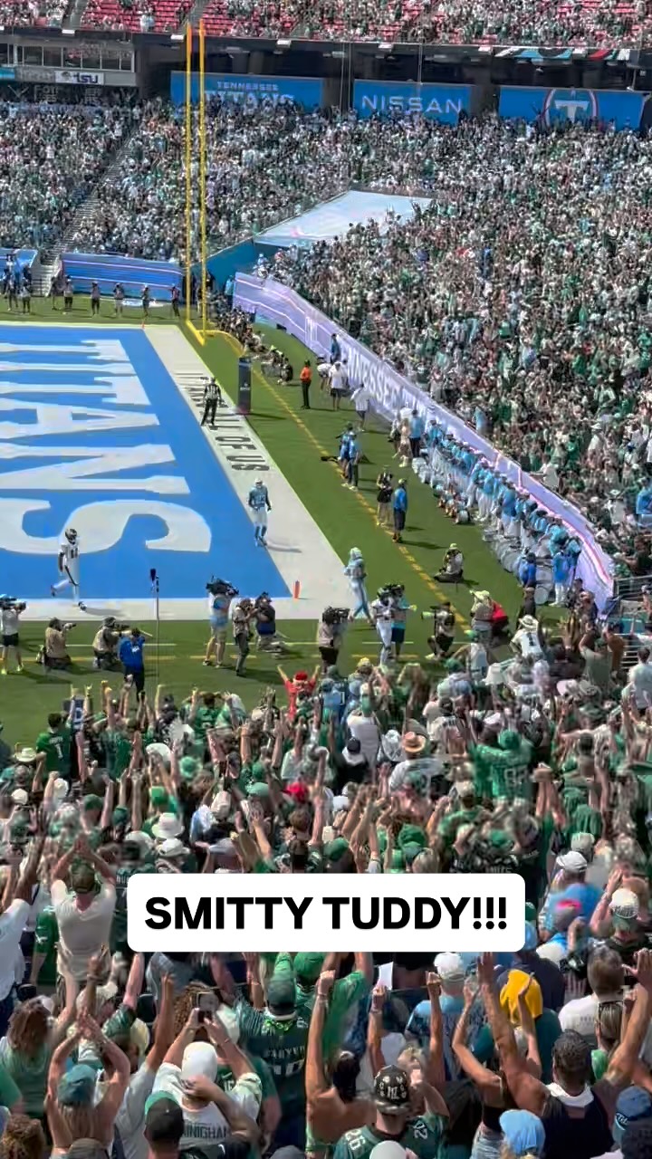 Fans celebrate a touchdown by Smitt...