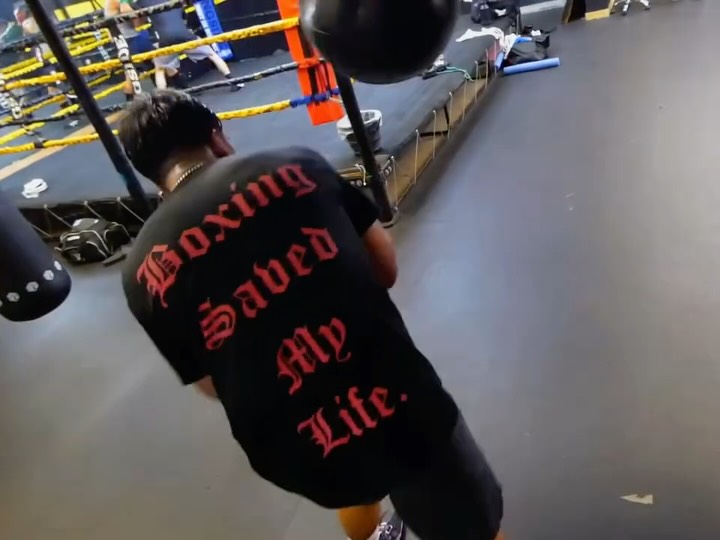 A person wearing a 'Boxing Saved My...