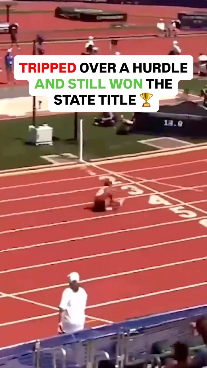 Track athlete trips over hurdle and...