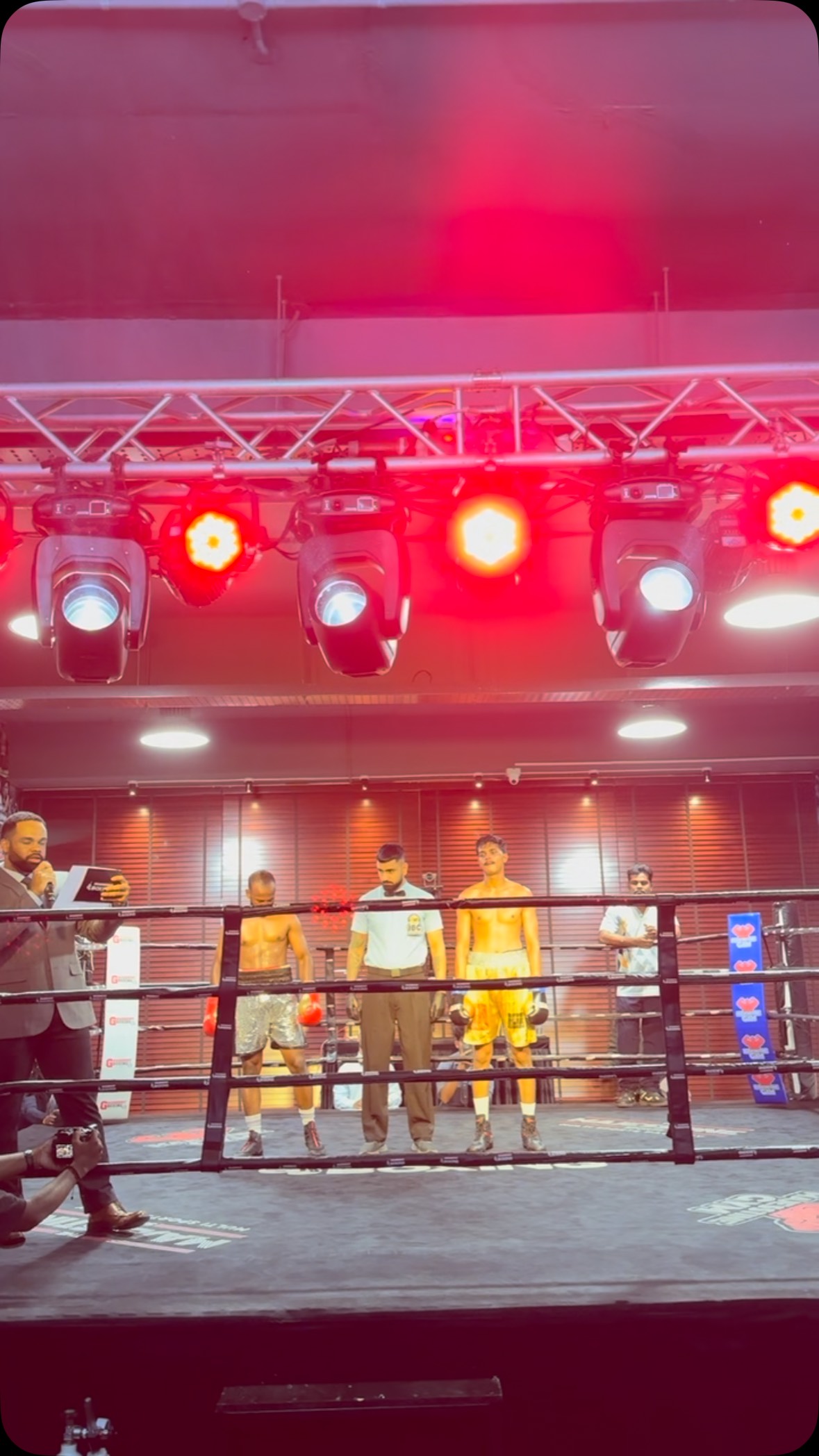 Boxers and referee in the ring