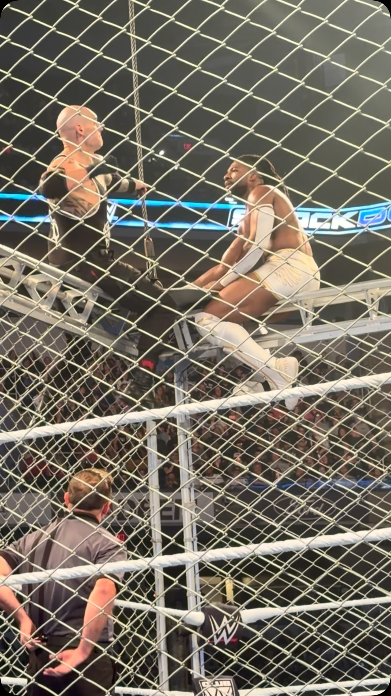 Wrestlers battle inside a steel cag...
