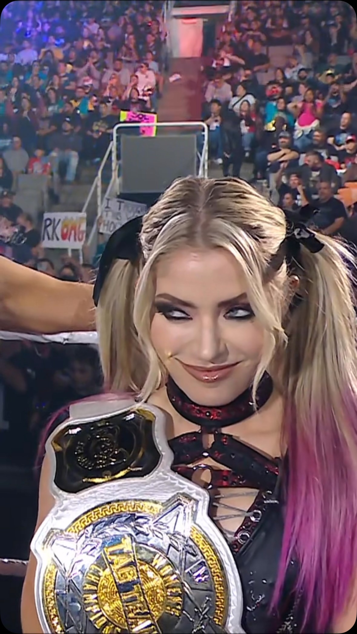 Alexa Bliss making a funny face whi...