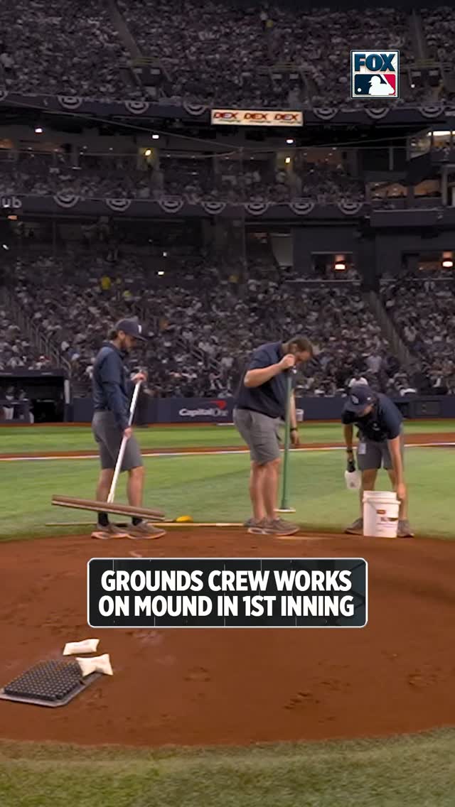 Grounds crew works on the mound in ...