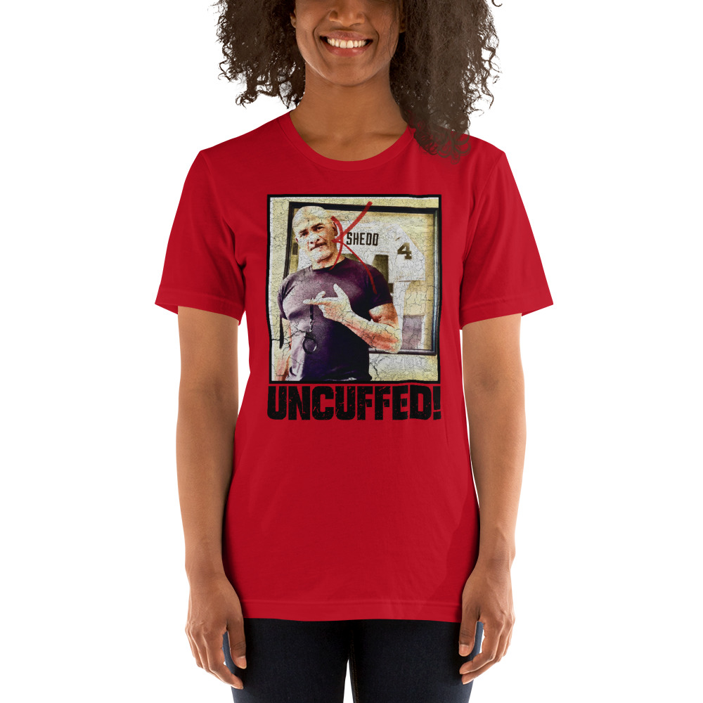 "Uncuffed!" by Kenny Shedd Shirt, Black Logo on MILLIONS "Uncuffed!" by Kenny Shedd Shirt, Black Logo